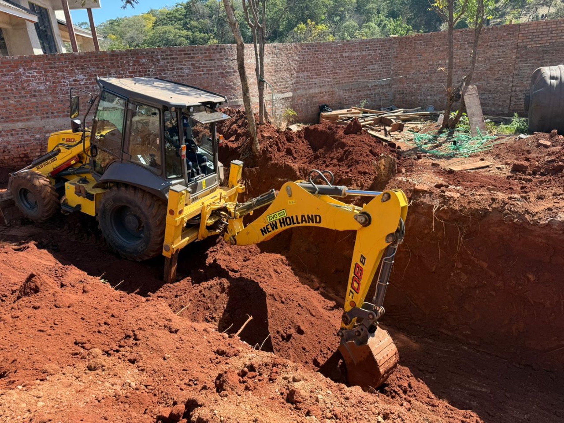 Backhoe excavating the foundation trench